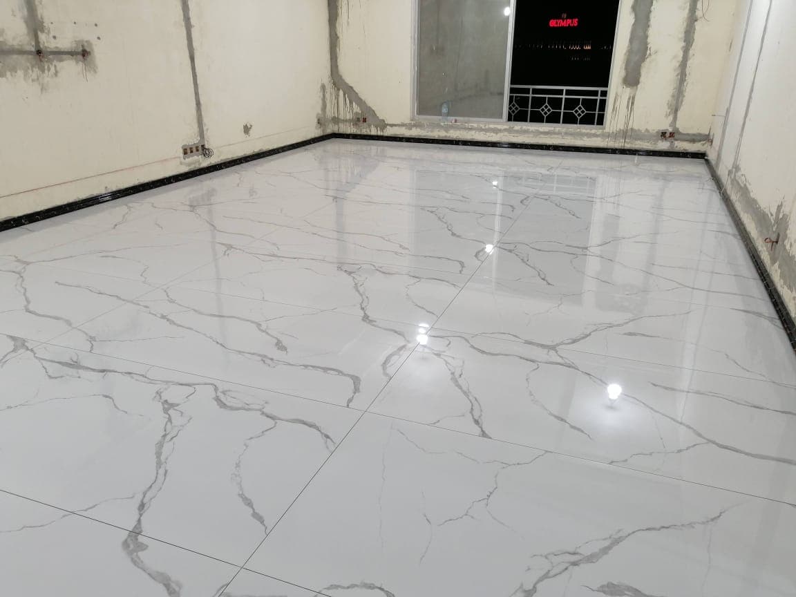 Finished marble-look porcelain floor with a dark border in a G-14 Islamabad house